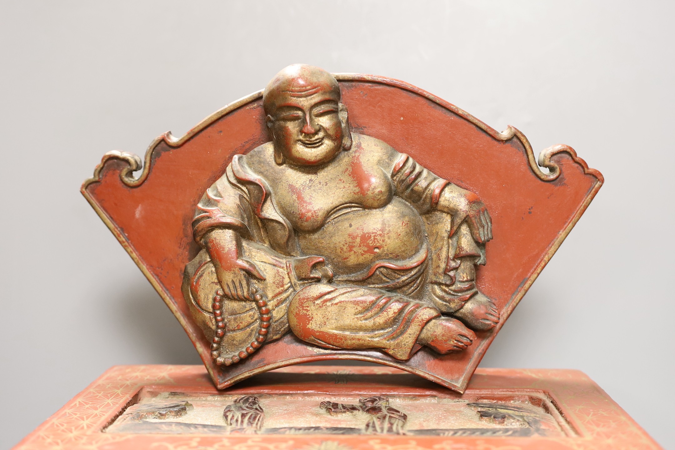 A Chinese lacquered wood Budai carving, 34cm wide, and a Chinese lacquered wood box (2)